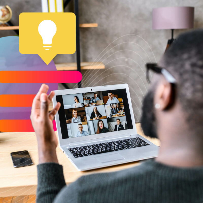 man video conferences with a team of people on his laptop