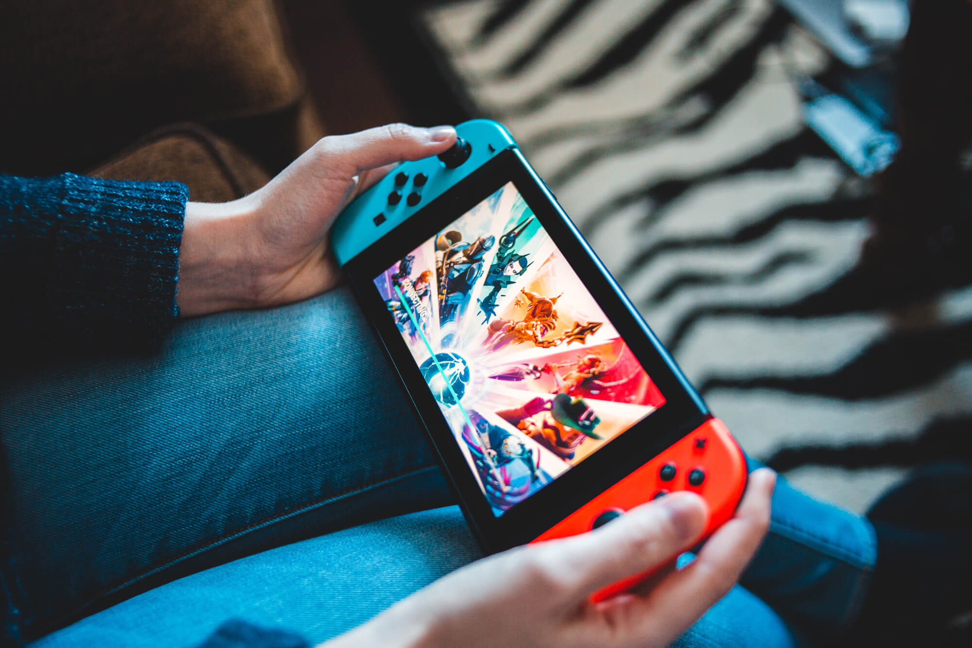 A person's hands are shown on a Nintendo Switch