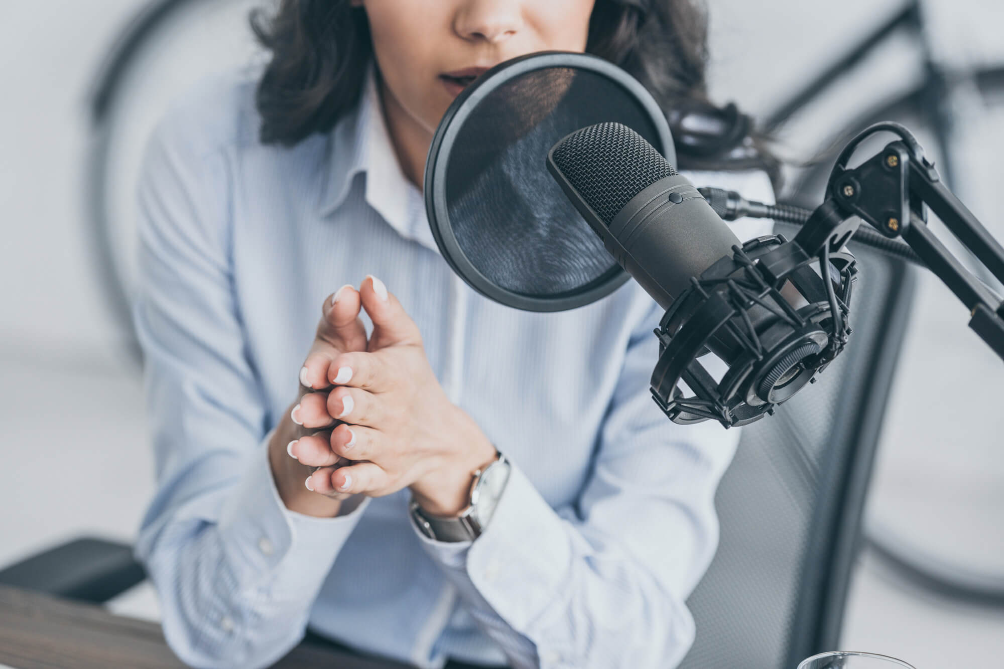 a woman records a podcast