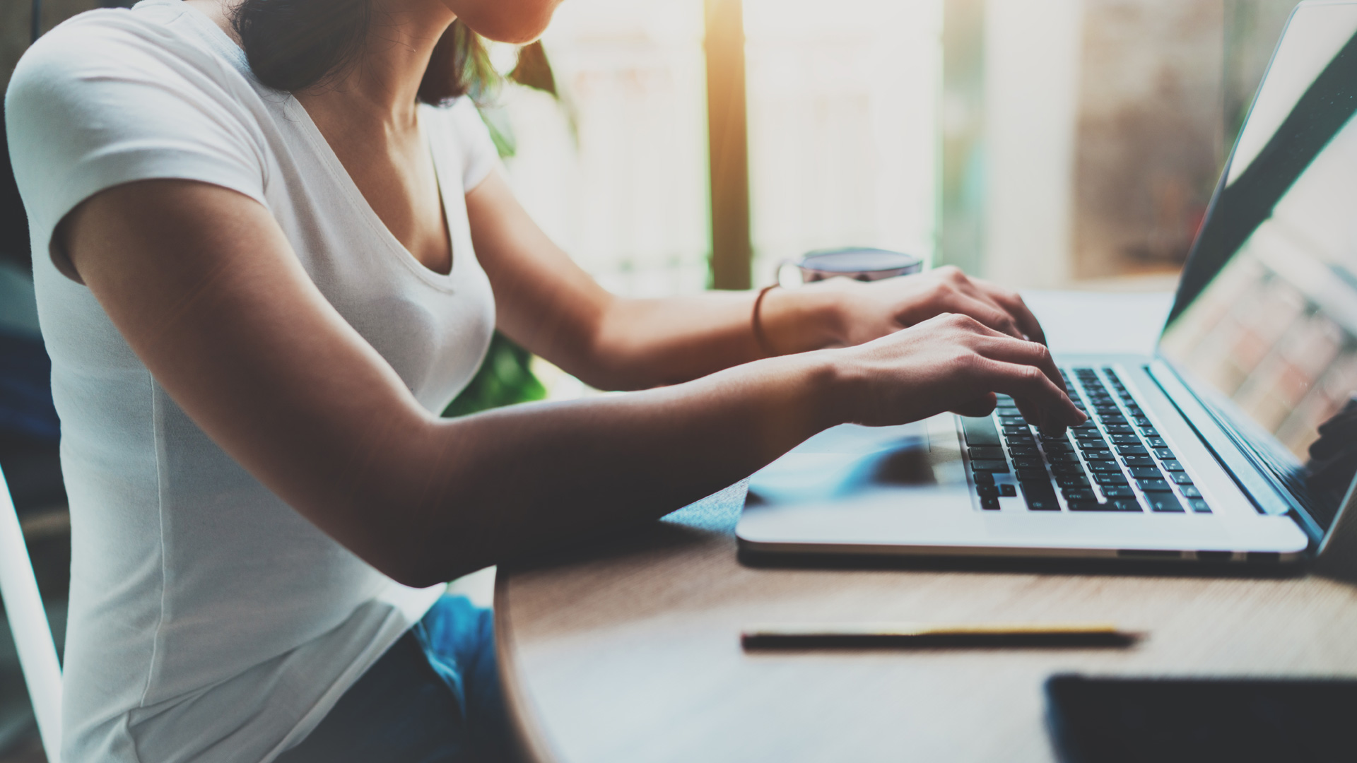 woman typing on a laptop