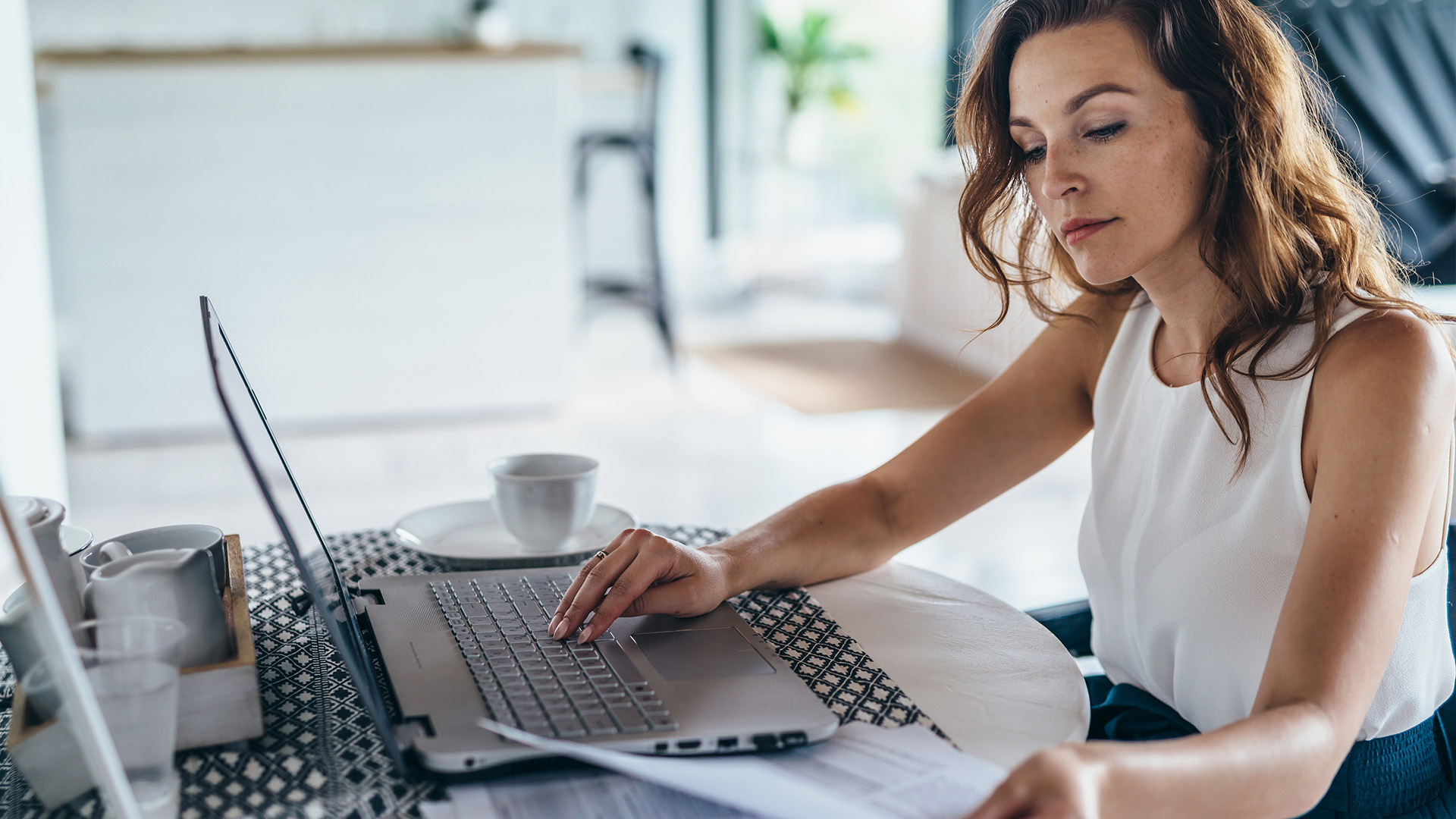 A content marketer types on a laptop keyboard