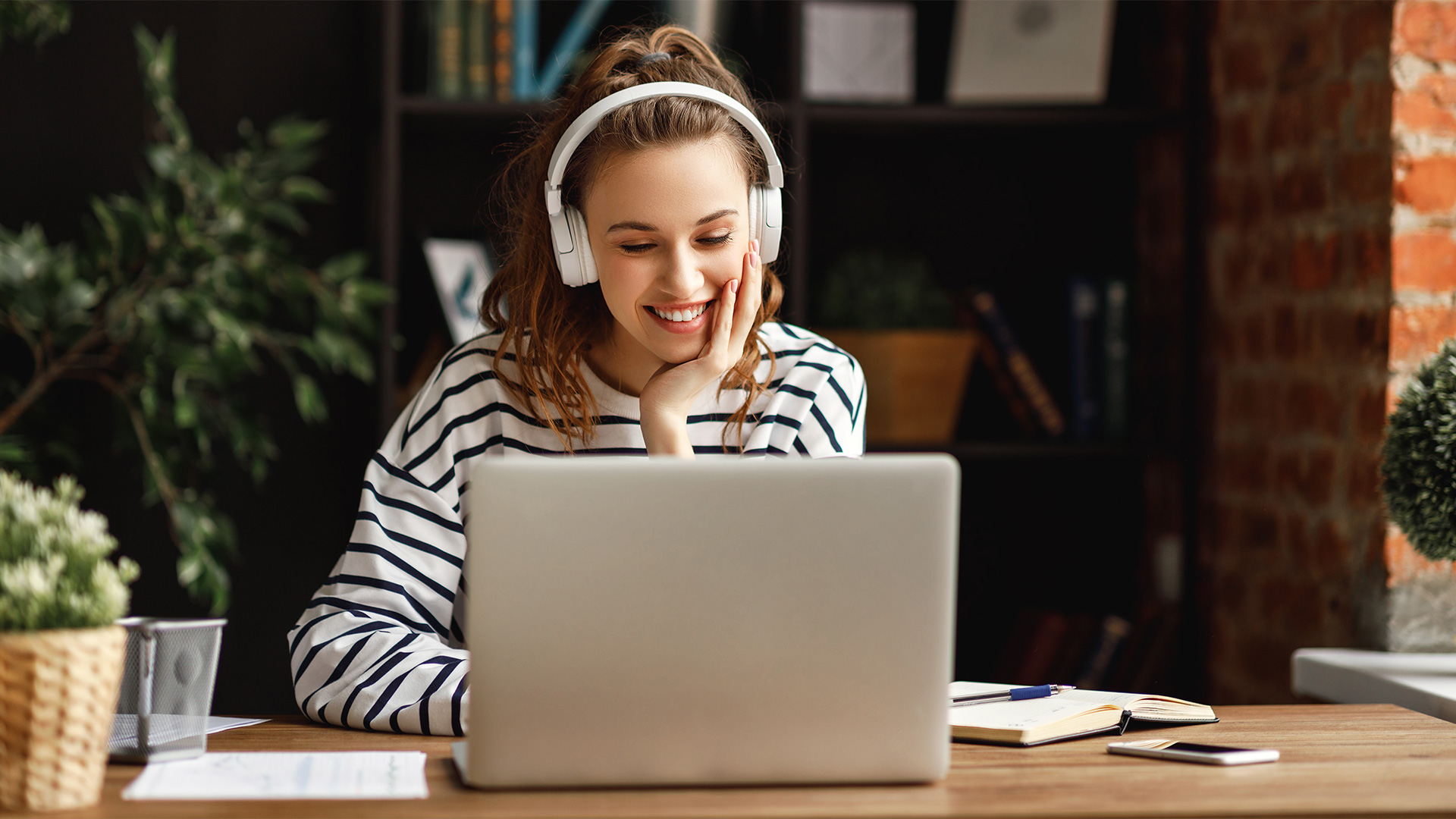 A woman typing on her computer about thinks to consider when using chatbots